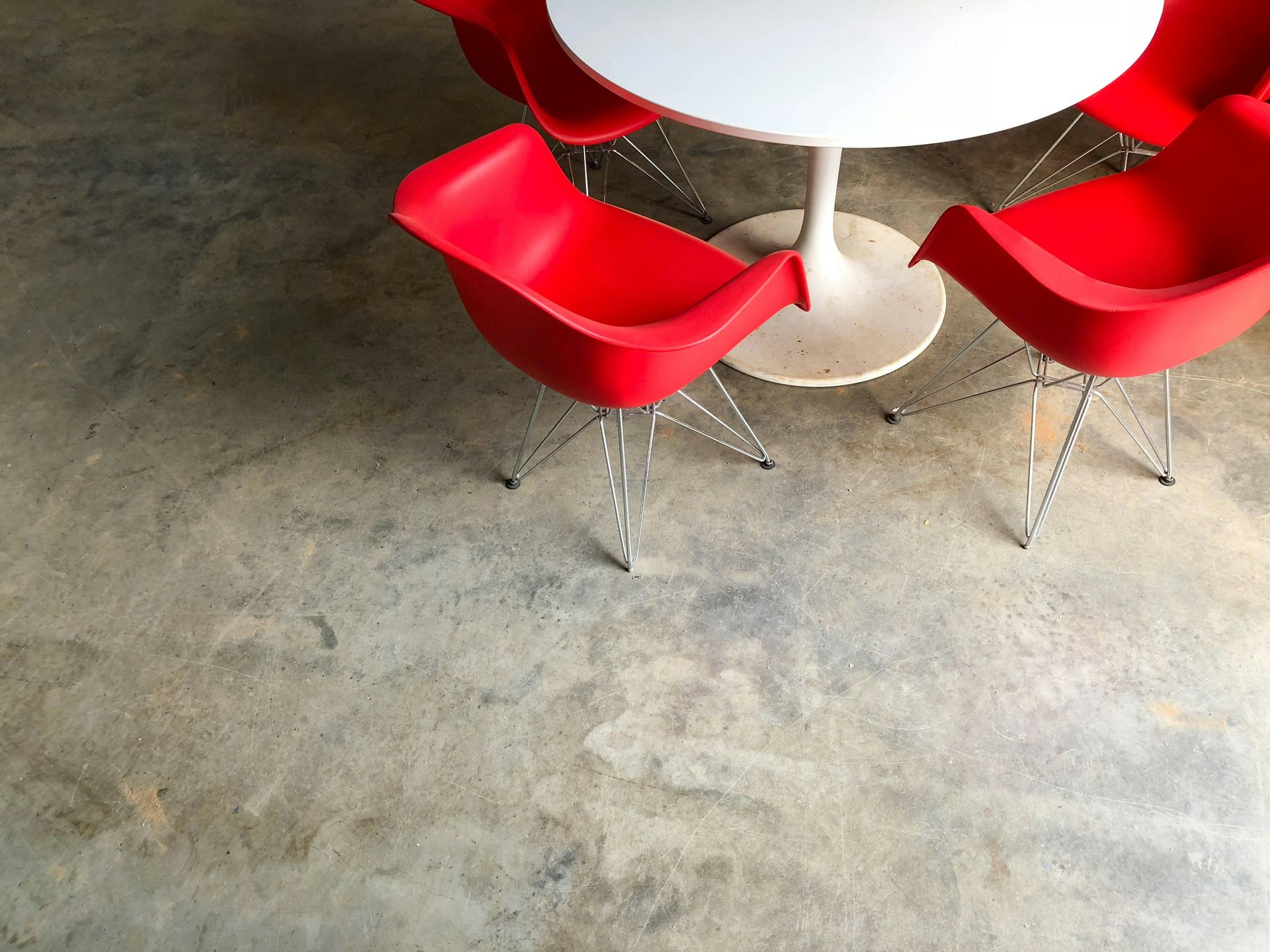 red plastic chairs near white pedestal table